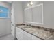Bathroom with vanity, marble countertop, mirror, and modern fixtures at 119 White Pine Dr, Rotonda West, FL 33947