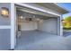 Open two car garage with an epoxy floor, lighting, and equipment at 119 White Pine Dr, Rotonda West, FL 33947
