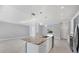 Bright kitchen featuring a marble island, stainless steel appliances, white cabinetry, and an open design at 119 White Pine Dr, Rotonda West, FL 33947