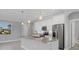Bright kitchen with white cabinets, stainless appliances, and a large island with granite countertop at 119 White Pine Dr, Rotonda West, FL 33947