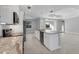 Open kitchen showcasing a central island with marble countertops, stainless steel appliances, and ample storage space at 119 White Pine Dr, Rotonda West, FL 33947