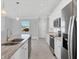Modern kitchen with stainless steel appliances, a central island, and a bright, open layout at 119 White Pine Dr, Rotonda West, FL 33947