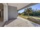 Covered patio overlooking a yard with native plants and trees at 119 White Pine Dr, Rotonda West, FL 33947