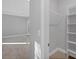 Walk in closet with custom shelving and rod and a tile floor at 119 White Pine Dr, Rotonda West, FL 33947
