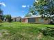 Expansive backyard with green grass and mature trees, offering plenty of space for recreation and relaxation at 13278 Carter Ave, Port Charlotte, FL 33981