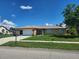 Lovely home with a well-kept front yard, an attached garage, and a mailbox located near the street at 13278 Carter Ave, Port Charlotte, FL 33981
