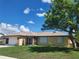 Charming single-story home with a well-manicured lawn and beautiful landscaping and an attached two-car garage at 13278 Carter Ave, Port Charlotte, FL 33981