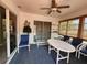 Bright sunroom with casual seating, a ceiling fan, and sliding door access to the outside at 13278 Carter Ave, Port Charlotte, FL 33981