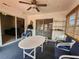 Relaxing sunroom featuring casual seating, a table, and sun shades at 13278 Carter Ave, Port Charlotte, FL 33981