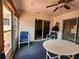 Cozy sunroom featuring multiple windows and doors, comfortable seating, and blue carpet at 13278 Carter Ave, Port Charlotte, FL 33981
