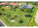 Large backyard with tropical landscaping, pool, and spacious patio at 13307 Eisenhower Dr, Port Charlotte, FL 33953