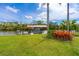 Backyard featuring lush grass, tropical plants, and seating area to take in the waterway view at 13307 Eisenhower Dr, Port Charlotte, FL 33953