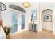 Bright and airy entryway with double doors, decorative accents, and tile flooring at 13307 Eisenhower Dr, Port Charlotte, FL 33953