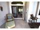 Inviting front porch with wicker seating and access to the interior of the home at 13307 Eisenhower Dr, Port Charlotte, FL 33953