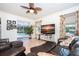 Relaxing Gathering room with leather furniture, pool view, and large TV at 13307 Eisenhower Dr, Port Charlotte, FL 33953