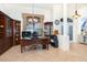Home office features built-in shelving, a large desk, and a computer setup at 13307 Eisenhower Dr, Port Charlotte, FL 33953