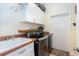 Bright laundry room, washer, dryer, and storage cabinets at 13307 Eisenhower Dr, Port Charlotte, FL 33953
