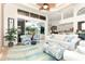Comfortable living room with sofas, ottomans, and sliding glass doors leading to the pool area at 13307 Eisenhower Dr, Port Charlotte, FL 33953