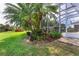 Landscaped pool area with lush tropical plants at 13307 Eisenhower Dr, Port Charlotte, FL 33953