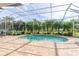 Inviting kidney shaped pool with screened enclosure at 13307 Eisenhower Dr, Port Charlotte, FL 33953