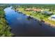 A panoramic view of a waterfront property with a private dock, perfect for boating and enjoying the scenic water views at 13307 Eisenhower Dr, Port Charlotte, FL 33953