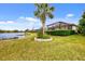Expansive backyard featuring a lake view and lush landscaping at 13376 Creekside Ln, Port Charlotte, FL 33953