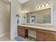 Well-lit bathroom with a large mirror, double vanity, and decorative touches at 13376 Creekside Ln, Port Charlotte, FL 33953