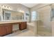 Luxurious bathroom with double vanity, soaking tub, tiled shower, and soft lighting at 13376 Creekside Ln, Port Charlotte, FL 33953