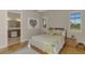 Comfortable bedroom with natural light, hardwood floors, neutral walls, and an en-suite bathroom at 13376 Creekside Ln, Port Charlotte, FL 33953