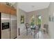 Cozy breakfast nook featuring a glass table, modern chairs, and views of the well-maintained backyard at 13376 Creekside Ln, Port Charlotte, FL 33953