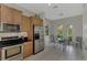 Eat-in kitchen area features stainless steel appliances, oak cabinetry, and an adjacent breakfast nook at 13376 Creekside Ln, Port Charlotte, FL 33953