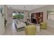 Bright living room with modern decor, tile floors, and sliding glass doors that provide views of the pool at 13376 Creekside Ln, Port Charlotte, FL 33953