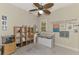 Bright office space with custom shelving, ceiling fan, and inspiring wall art at 13376 Creekside Ln, Port Charlotte, FL 33953