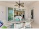 Covered patio with dining furniture, open to the interior through sliding glass doors at 13376 Creekside Ln, Port Charlotte, FL 33953
