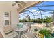 Screened-in pool and patio area featuring a dining table and lounge chairs at 13376 Creekside Ln, Port Charlotte, FL 33953