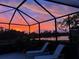 Patio with outdoor seating overlooking lake at sunset at 13376 Creekside Ln, Port Charlotte, FL 33953