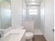 Modern bathroom with a white vanity, tiled shower with glass partition, and neutral finishes at 159 Colony Point Dr, Punta Gorda, FL 33950