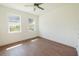 Bright bedroom with two windows, ceiling fan, and a neutral color palette at 159 Colony Point Dr, Punta Gorda, FL 33950
