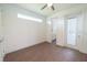 A bedroom with wood floors and white walls. There is a door leading to the bathroom at 159 Colony Point Dr, Punta Gorda, FL 33950