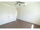 A spacious bedroom with wood flooring, closet, and a view into another room at 159 Colony Point Dr, Punta Gorda, FL 33950