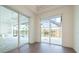 Dining area with sliding glass doors offering scenic waterfront view and modern lighting fixture at 159 Colony Point Dr, Punta Gorda, FL 33950