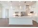 Spacious kitchen with large center island, white cabinets, stainless appliances, and open floor plan at 159 Colony Point Dr, Punta Gorda, FL 33950