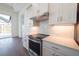 Well-lit kitchen featuring white cabinets, stainless steel appliances, quartz countertops and a decorative backsplash at 159 Colony Point Dr, Punta Gorda, FL 33950