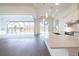Open-concept design featuring kitchen with island and view to screened lanai and pool at 159 Colony Point Dr, Punta Gorda, FL 33950