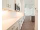 Kitchen with white cabinets, stainless steel appliances, stylish hardware and a view to an adjacent room at 159 Colony Point Dr, Punta Gorda, FL 33950