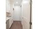 Well-lit laundry room featuring white cabinets, quartz counters, and a stainless steel sink at 159 Colony Point Dr, Punta Gorda, FL 33950