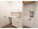 Clean laundry room featuring white cabinets, a quartz countertop, and a stainless steel sink at 159 Colony Point Dr, Punta Gorda, FL 33950
