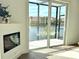 Living area with floor-to-ceiling sliding glass doors and a fireplace offering great natural lighting at 159 Colony Point Dr, Punta Gorda, FL 33950