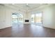Living area featuring glass sliding doors to the pool deck, a fireplace, and neutral paint at 159 Colony Point Dr, Punta Gorda, FL 33950