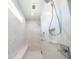 Shower with multiple shower heads and sleek white tile at 159 Colony Point Dr, Punta Gorda, FL 33950